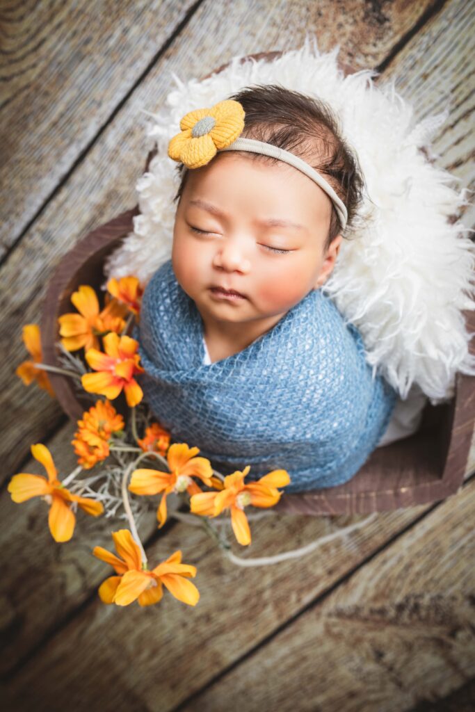 newborn girl with flowers