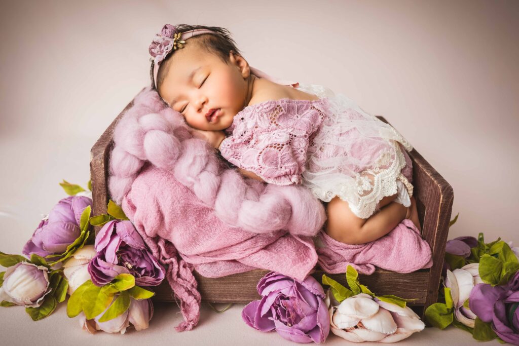 newborn girl in small bed